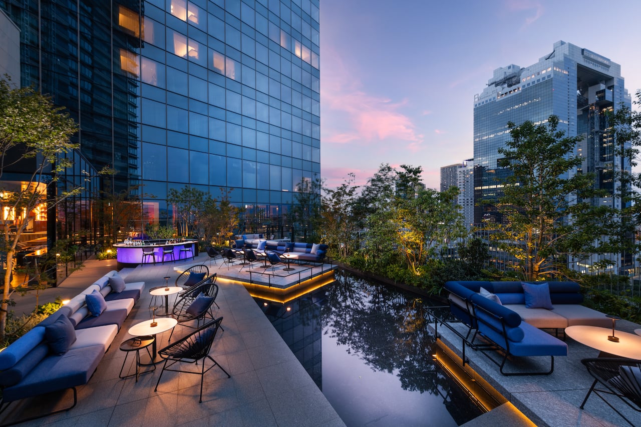 JaJa Bar terrasse with blue and white sofas and tables at night.