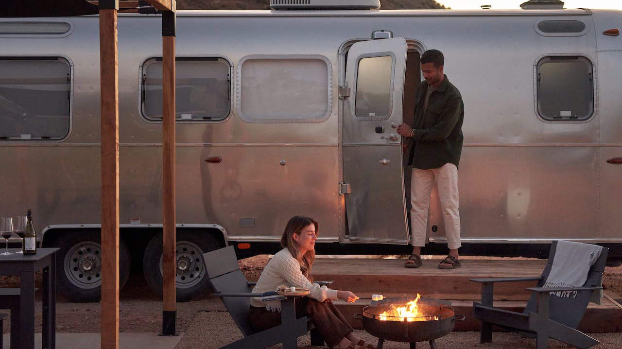 Two people by a campfire