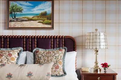 Bed in room with lamp and art on wall