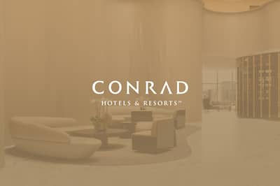 Atrium of the Conrad Washington with Conrad Hotels & Resorts logo layered over the image