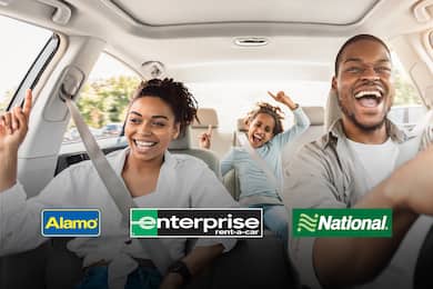 Family of three having fun in a rental car