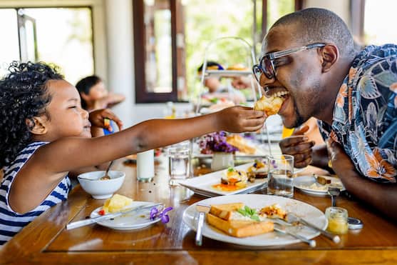 Father And Daughter Having Breakfast