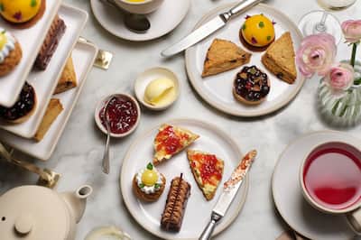 Selection of cakes, jams and drinks on display
