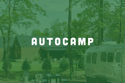 An AutoCamp destination inclusing Airstream and Clubhouse with the AutoCamp logo lover the top of the image