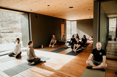 Group of people sitting on mats doing yoga