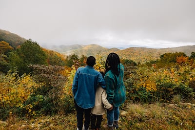 Three people admiring mountain views