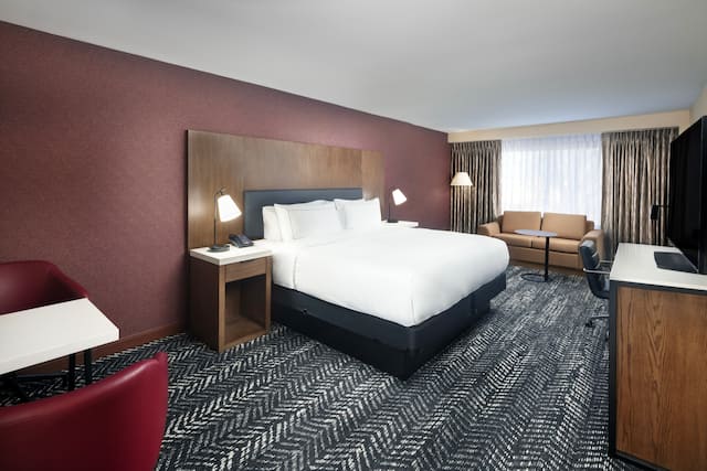 King Guest Room with Bed, Sofa, Work Desk, and TV