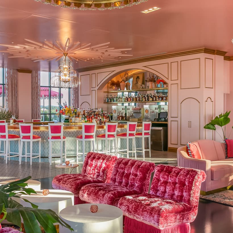 White Limozeen bar at the Graduate by Hilton Nashville. A large room filled with pink furniture and seating