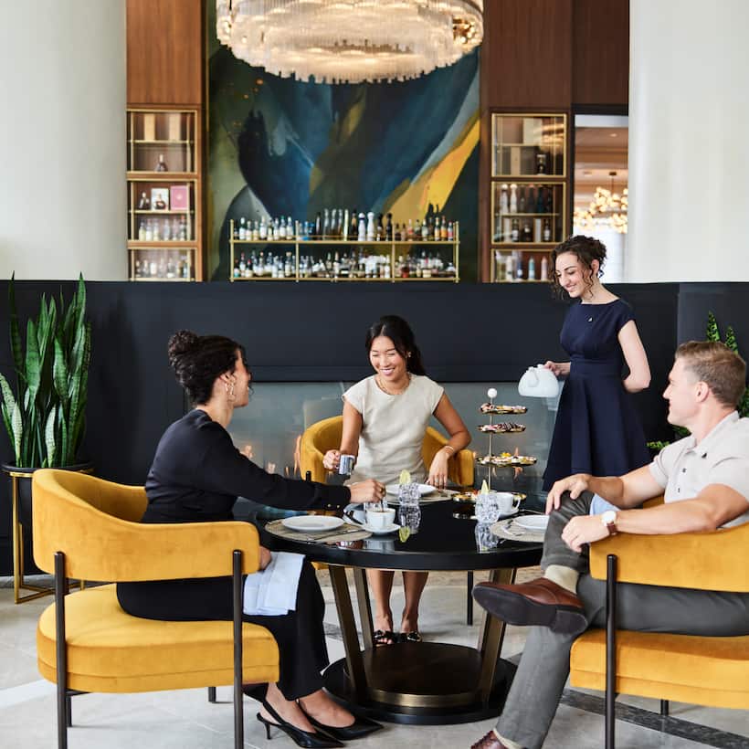 Group of friends having afternoon tea in restaurant