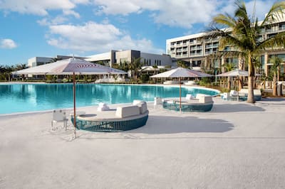 outdoor pool, daybed lounge chairs with umbrellas