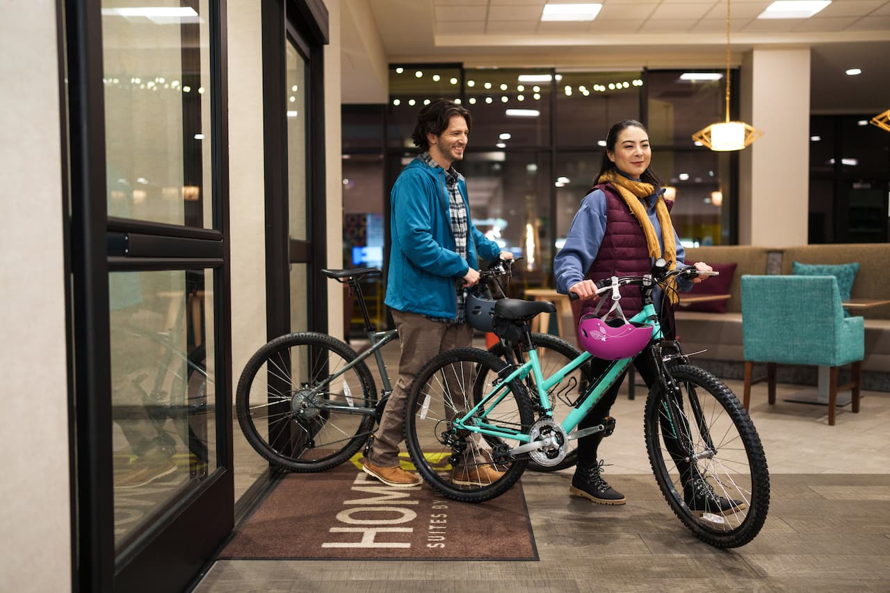 Couple with bikes in hotel lobby