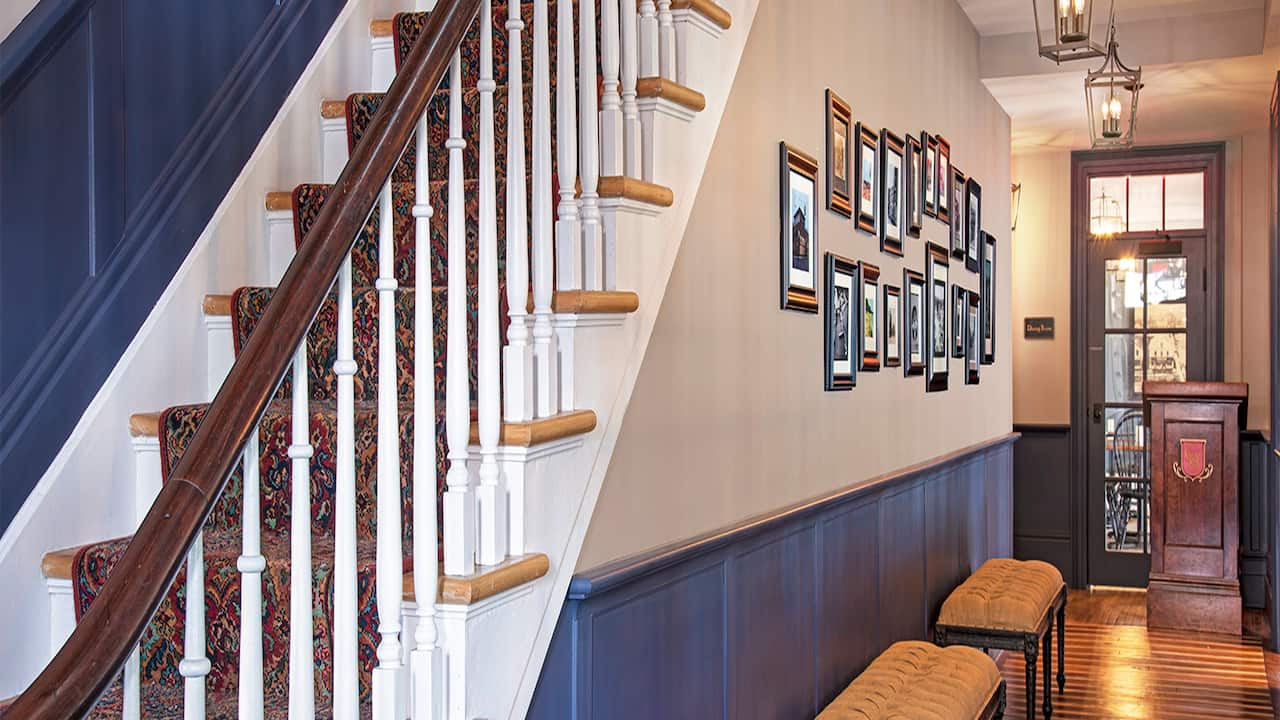 Foyer with bench seating and stairs leading to the second floor