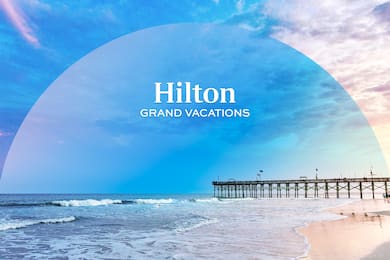 A beachfront sunrise by a pier