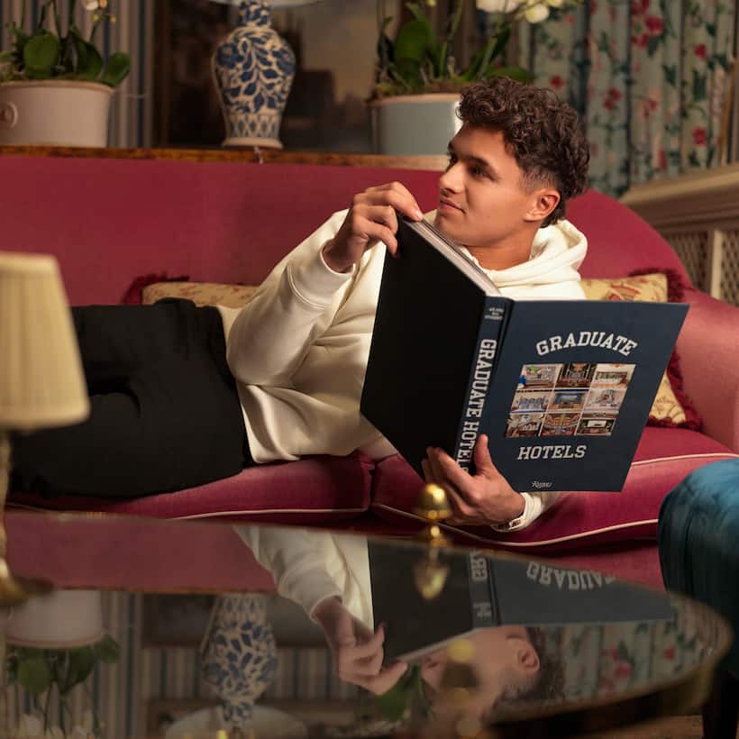 Lando Norris relaxes with book at Graduate Hotel by Hilton