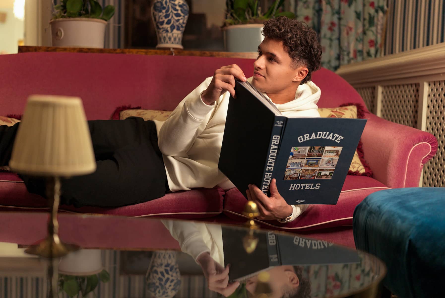 Lando Norris relaxes with book at Graduate Hotel by Hilton