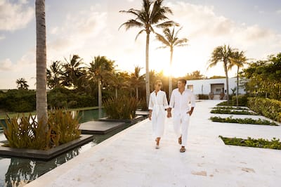 couple walking through the hotel garden / courtyard