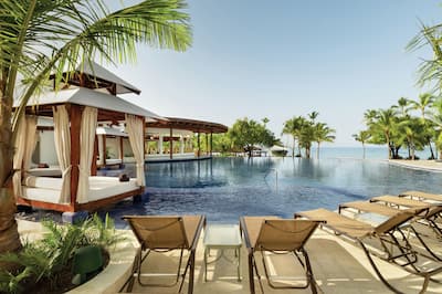 Outdoor Pool Area with Lounge Chairs and Cabanas