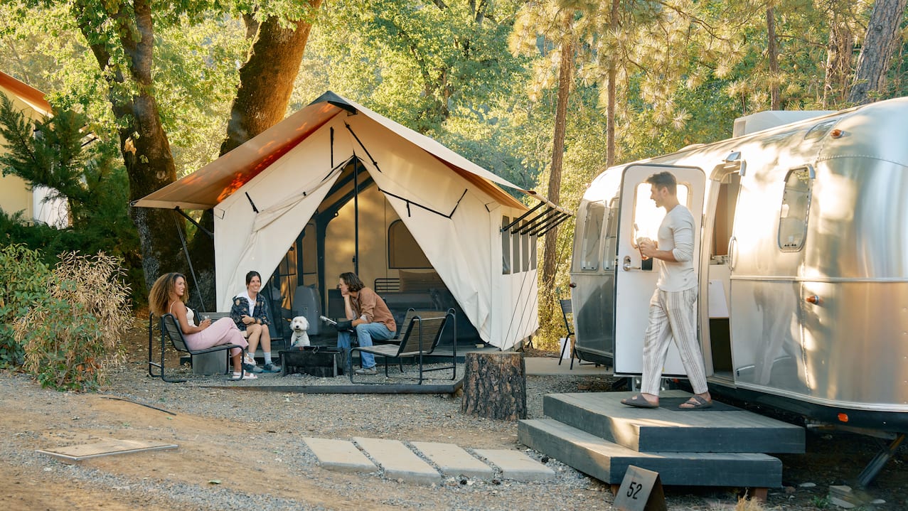 Static home with tent, and people relaxing