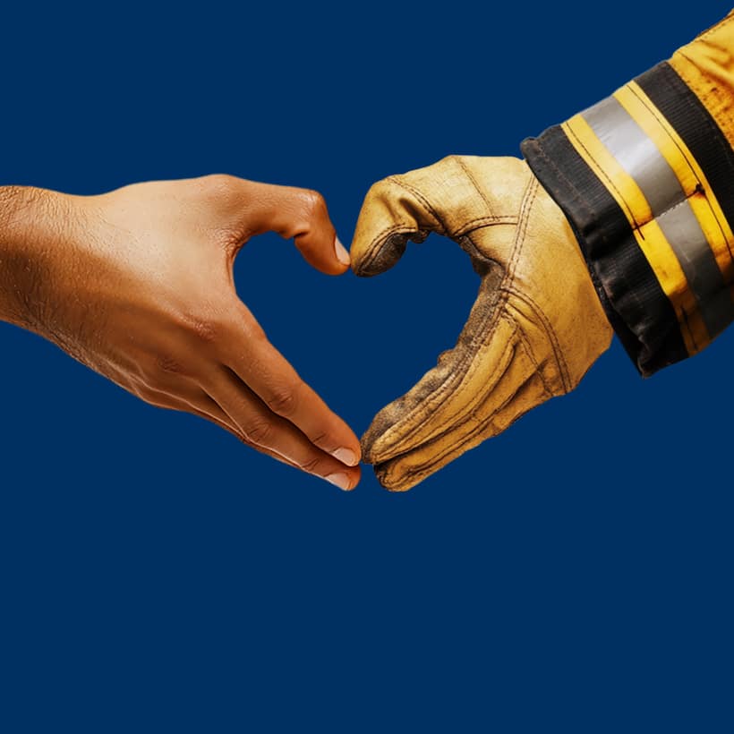 Hilton LA Wildfire Person and a Firefighter make a heart with their hands