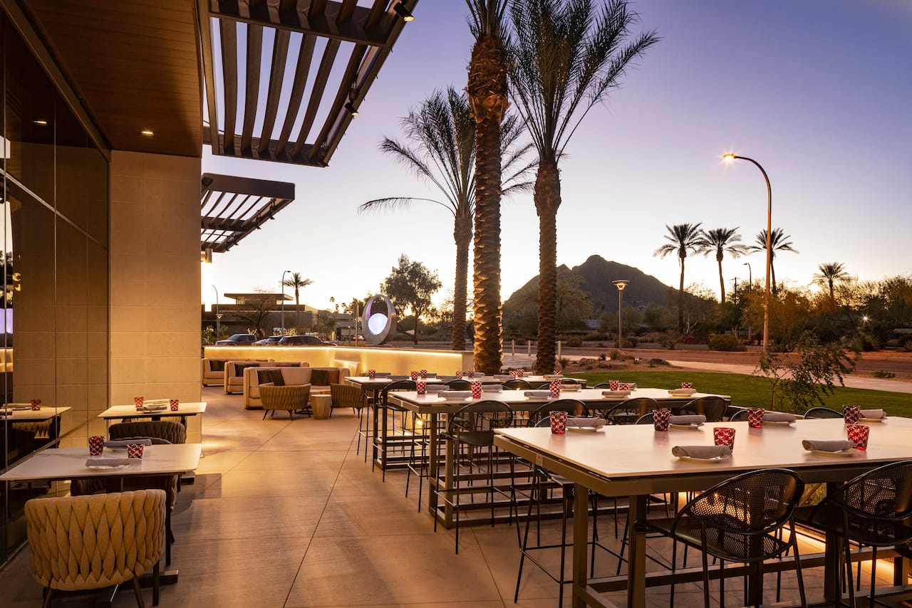 Outdoor seating area with tables and chairs