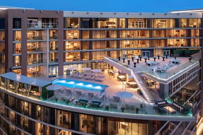 Rooftop pool with seating area and tables set up for event