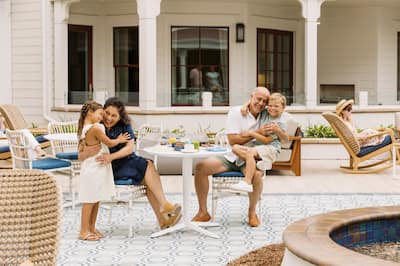 man and woman with children at outdoor table