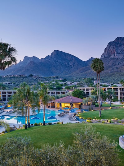 View of hotel property with mountain backdrop.