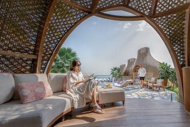 Woman sitting on comfortable seating in shaded area