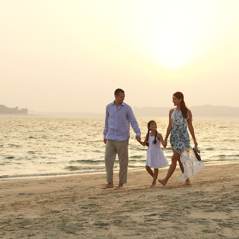Family Walking On Beach