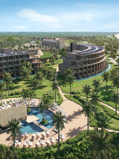 Aerial view of resort, with buildings, trees and outdoor pool